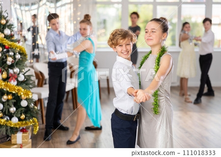 Teenage students rehearsing ballroom dance number for upcoming Christmas party 111018333