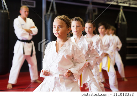 Young boys and girls in kimono doing kata Young boys and girls in kimono doing kata 111018358