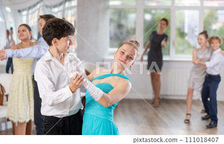 Teenage students rehearsing ballroom dance while preparing for college festive event 111018407