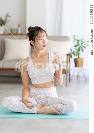 Fitness yoga woman drinking water 111019851