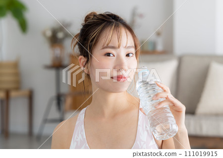 Fitness yoga woman drinking water 111019915