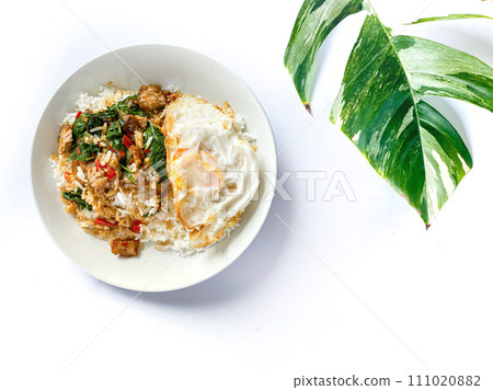 Rice topped with crispy pork belly with Thai basil and fried egg 111020882
