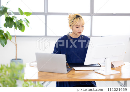 Business Young woman working on a computer Business Young woman working on a computer 111021669