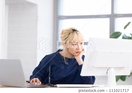 Business Young woman working on a computer Business Young woman working on a computer 111021717