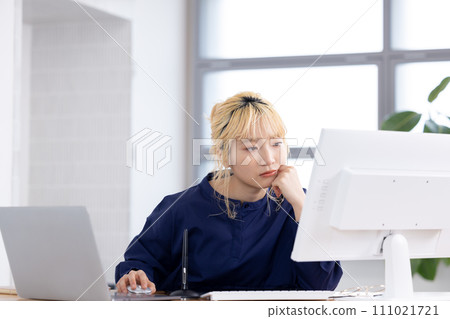 Business Young woman working on a computer Business Young woman working on a computer 111021721