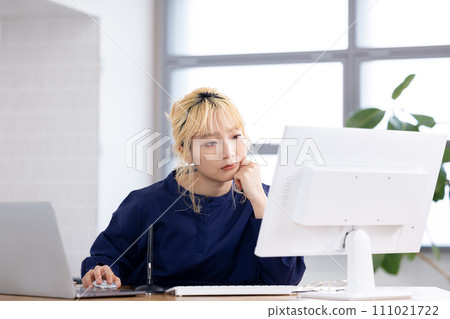 Business Young woman working on a computer Business Young woman working on a computer 111021722
