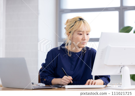 Business Young woman working on a computer Business Young woman working on a computer 111021725