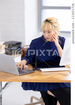 Business Young woman working on a computer Business Young woman working on a computer 111021726