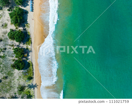 Aerial view of Waves crashing on sandy shore,Sea surface ocean waves background,Top view beach background 111021759