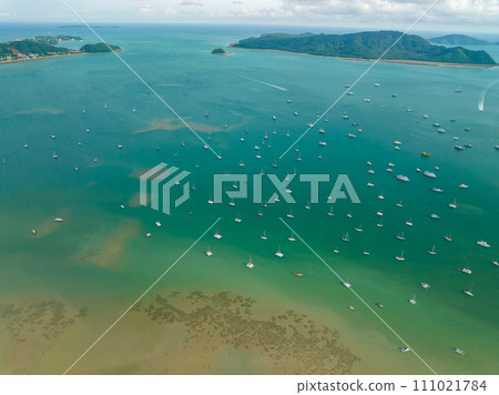 Aerial View Amazing sea with travel boats,sailing boats in the sea,Beautiful sea in summer season at Phuket island Thailand,Travel boats,Ocean during summer blue sky background 111021784