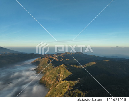Aerial view Mountains at Bromo volcano during sunrise sky,Beautiful Mountains Penanjakan in Bromo Tengger Semeru National Park,East Java,Indonesia.Nature landscape background Aerial view Mountains at Bromo volcano during sunrise sky,Beautiful Mountains Penanjakan in Bromo Tengger Semeru National Park,East Java,Indonesia.Nature landscape background 111021926