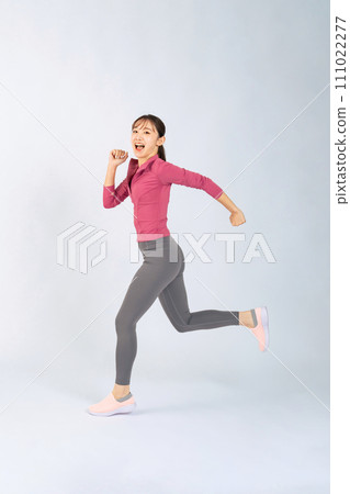 A woman wearing sportswear running 111022277
