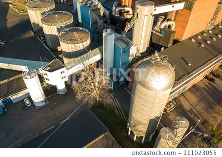Aerial view of big fuel reservoirs in petroleum industrial zone and metal exhaust pipes of oil refinery factory. Aerial view of big fuel reservoirs in petroleum industrial zone and metal exhaust pipes of oil refinery factory. 111023055