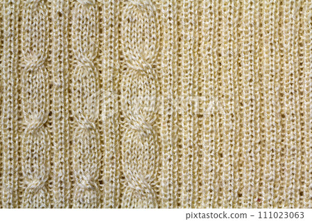 Background texture of beige pattern knitted fabric made of cotton or wool closeup 111023063