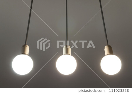 LED white bulbs hanging from the ceiling. Illumination technology. 111023228