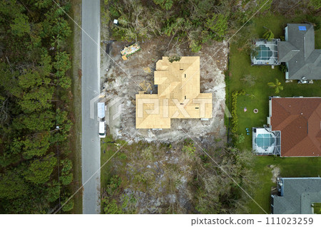 Aerial view of residential private home with wooden roofing structure under construction in Florida quiet rural area. Real estate development concept 111023259