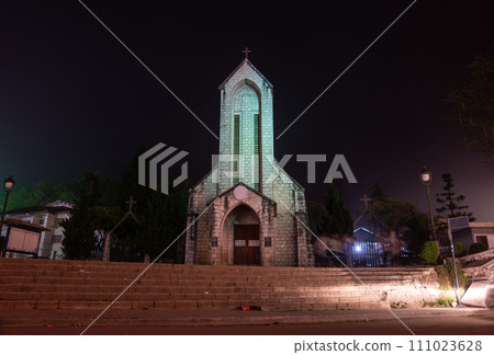 Night view of an iconic stone church of Sapa named Holy Rosary church the Gothic style church located in the heart of Sapa, Vietnam. Sapa is the resort town in Lao Cai province in Northwest Vietnam. 111023628