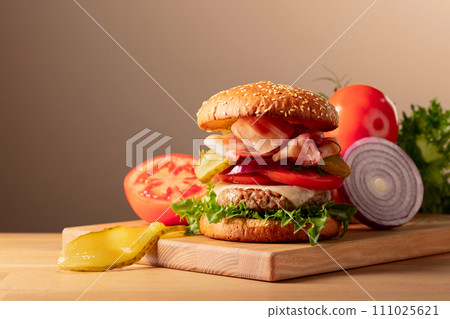Fresh tasty burger on a wooden cutting board. 111025621
