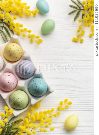 Colorful easter eggs  and mimosa flowers on wooden table. 111025690