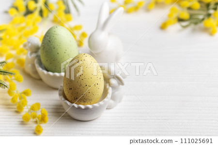 Colorful easter eggs  and mimosa flowers on concrete background 111025691