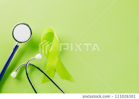 Green awareness ribbon and doctor stethoscope symbol of Gallbladder and Bile Duct Cancer month on green background with copy space, concept of medical and health care support, World bipolar day Green awareness ribbon and doctor stethoscope symbol of Gallbladder and Bile Duct Cancer month on green background with copy space, concept of medical and health care support, World bipolar day 111026301