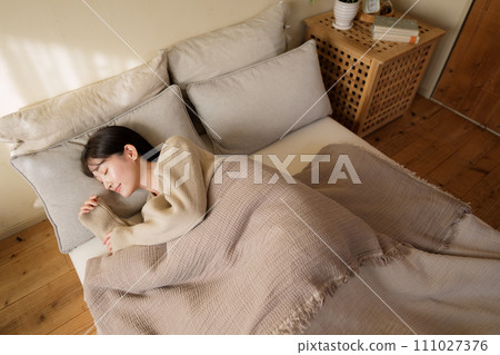 woman sleeping on bed in bedroom 111027376