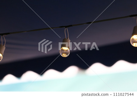 A light bulb hanging on the railing. A light bulb hanging on the railing. 111027544