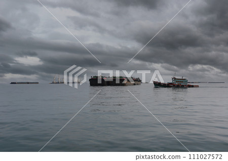 Tug boats and cargo ships moored in the bay of Koh Sichang, Chonburi Province of Thailand. 111027572