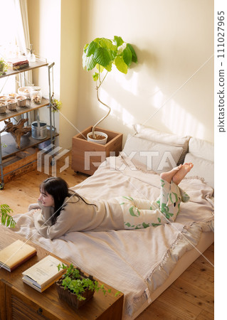 A woman relaxing on the bed 111027965