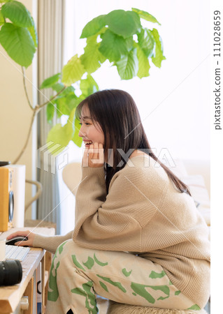 一位女士在房間使用電腦 111028659