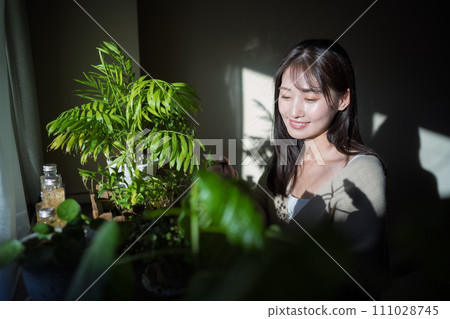 Women watering plants Women watering plants 111028745