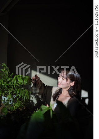 Women watering plants 111028750