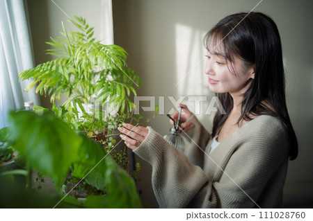 Women watering plants 111028760