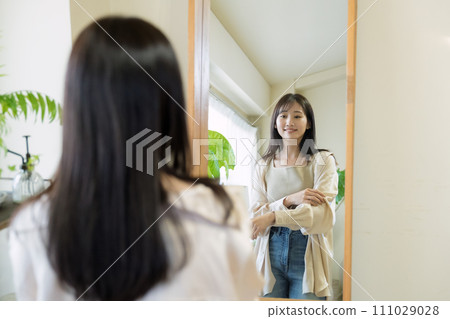 A woman choosing clothes A woman choosing clothes 111029028