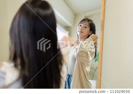 A woman choosing clothes A woman choosing clothes 111029030