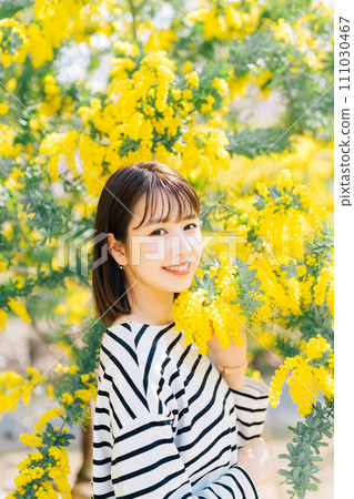 Mimosa and young woman 111030467