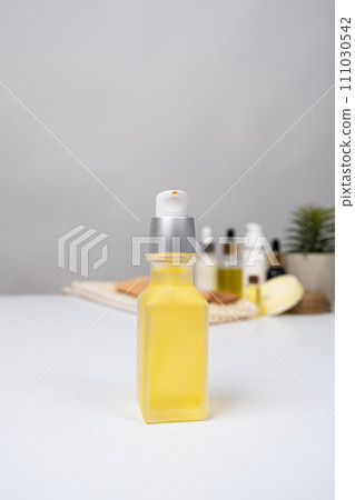 Oils in cosmetology, oil in a glass jar with a dispenser for the care of the skin of the face, body and hair 111030542