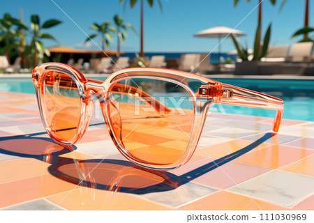 Sunglasses in a plastic frame with yellow glasses on the background of the pool in the hotel. The concept of summer holidays and recreation 111030969