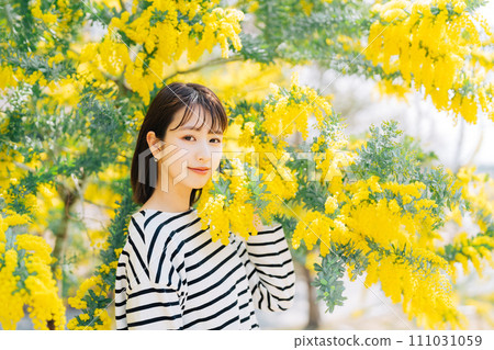 Mimosa and young woman 111031059