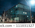 Soviet building at the night with a light in windows  111031327