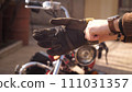Photo of a biker's hands in gold hours wear protection gloves with a red chopper 111031357
