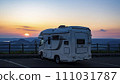 A camper van with the setting sun in the background from Lake Mashu Observation Deck 111031787