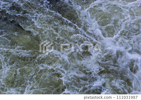 Close up detail of fierce white water river rapids from a clean deep green colored river forming a textured background Close up detail of fierce white water river rapids from a clean deep green colored river forming a textured background 111031987