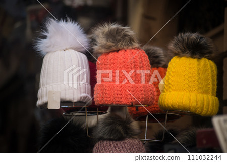 Closeup of colorful woolen hats at the market in the street Closeup of colorful woolen hats at the market in the street 111032244