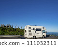A camper standing in the parking lot at the summit of Mt. Hachimantai on a sunny day 111032311