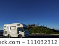 A camper standing in the parking lot at the summit of Mt. Hachimantai on a sunny day 111032312
