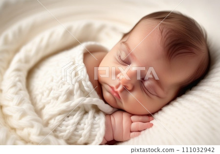 Sleeping newborn baby in a wrap on white blanket. Sleeping newborn baby in a wrap on white blanket. 111032942