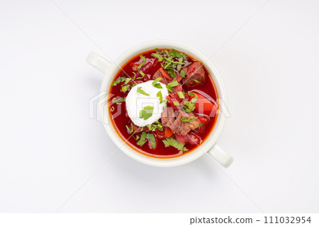 Business lunch. Traditional borscht with beef and sour cream in a white bowl on a white background 111032954