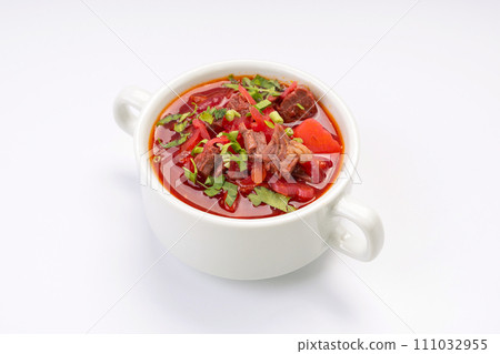 Business lunch. Traditional borscht with beef and sour cream in a white bowl on a white background Business lunch. Traditional borscht with beef and sour cream in a white bowl on a white background 111032955