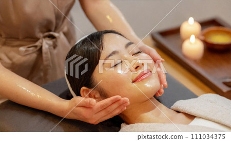 Woman receiving treatment at beauty salon, facial massage, oil massage Woman receiving treatment at beauty salon, facial massage, oil massage 111034375